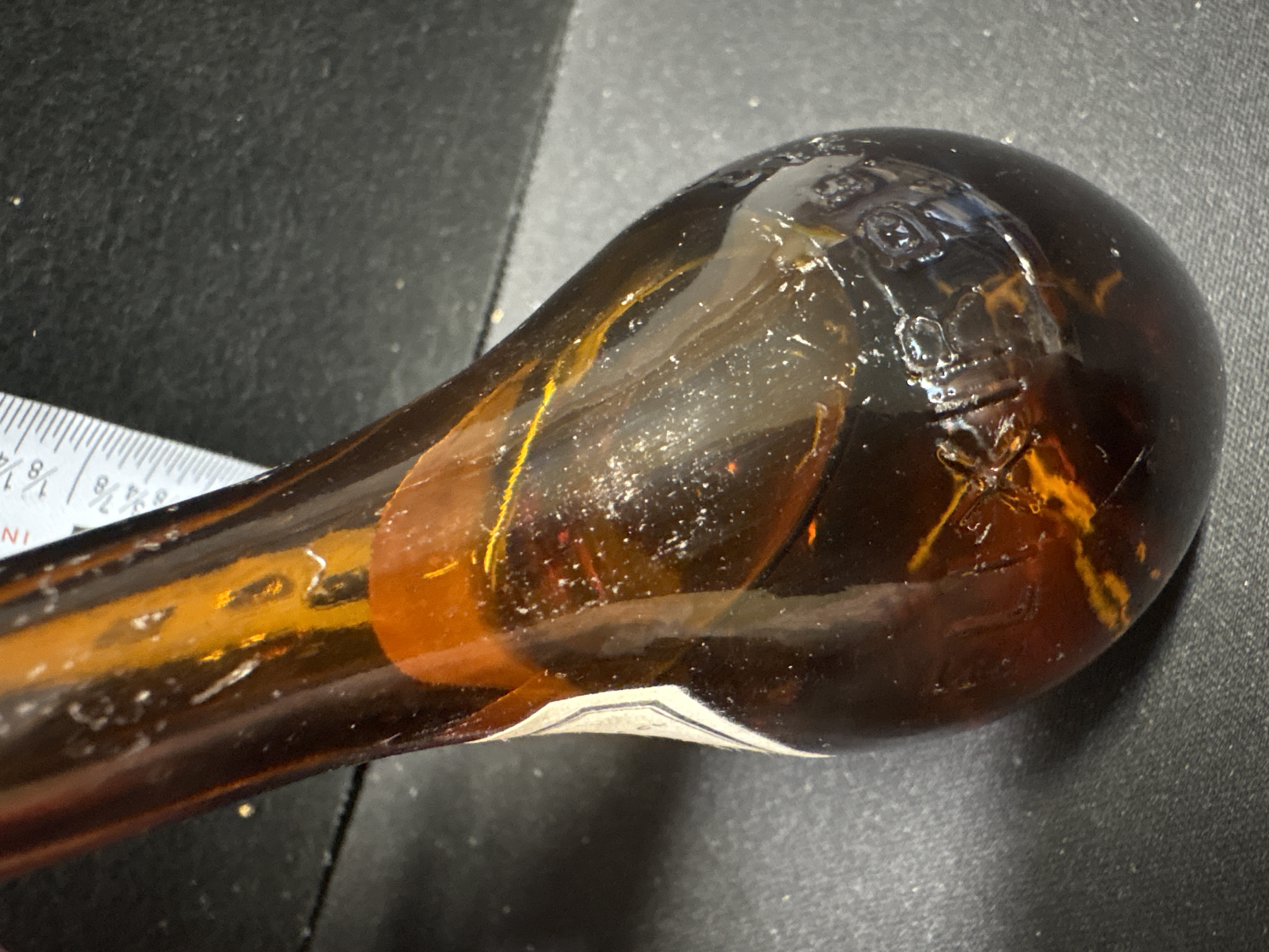 LOT 2026-542 — Petite bouteille de collection en verre ambré, avec bouchon rouge texturé et… — photo 2